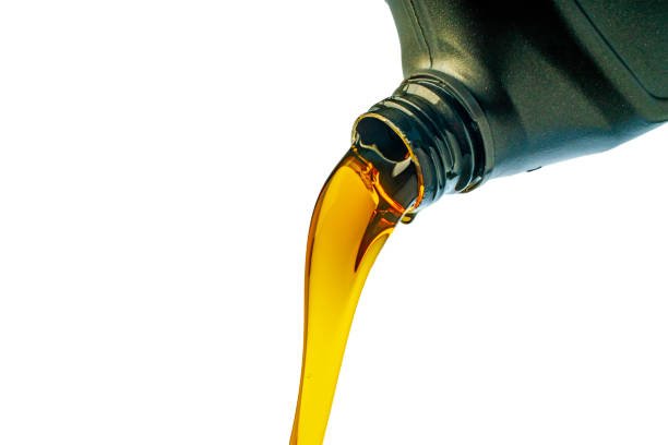 Car lubricant flows from gray bottle on isolated white background.