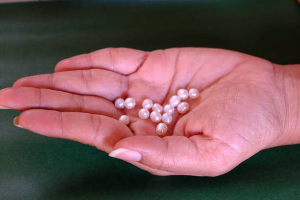 Pearls holding in hand-palm