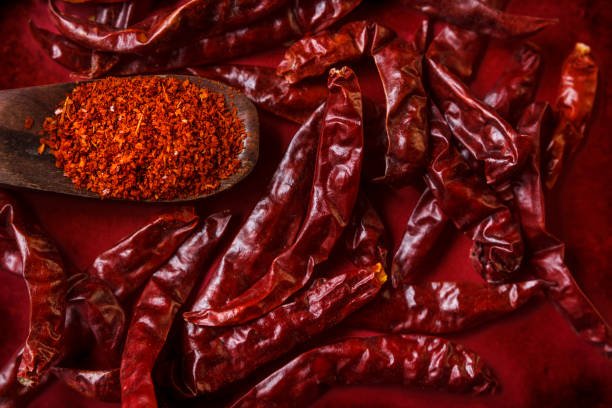Red dry chili peppers and powder with spoon