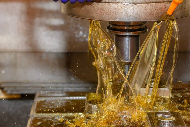 The CNC milling machine rough cutting the mold parts with liquid coolant method. The mold and die manufacturing process by CNC machining center.